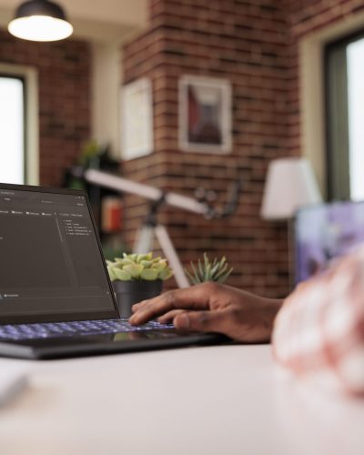 African american engineer programming app code, developing online software with cloud server and firewall security. Coding new user interface with binary code html program, web development.