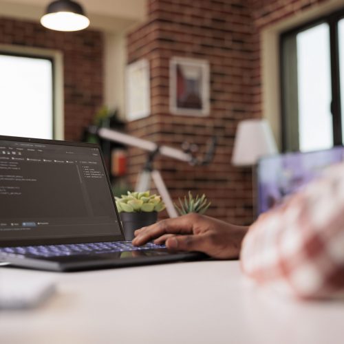 African american engineer programming app code, developing online software with cloud server and firewall security. Coding new user interface with binary code html program, web development.