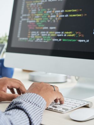 Cropped image of It specialist working on code