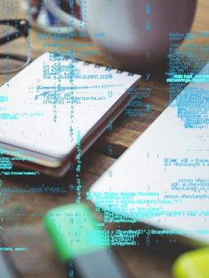 digital composite of laptop with notepad and coffee on table with graphics