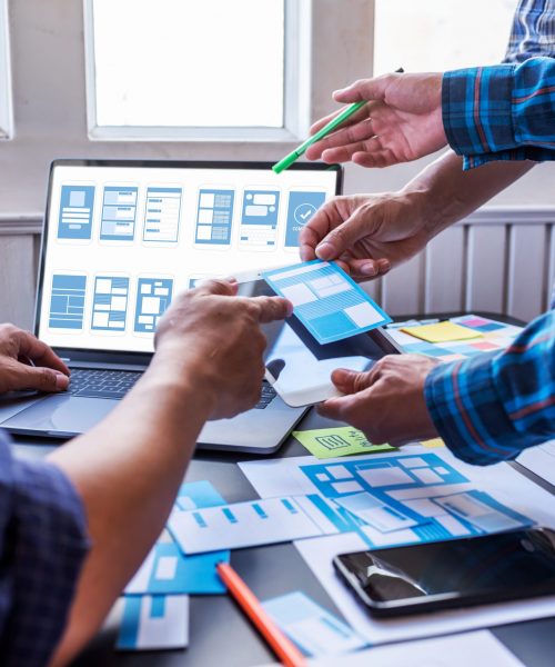 User Experience Teamwork Mobile UX/UI Designers working at co-working space workroom.